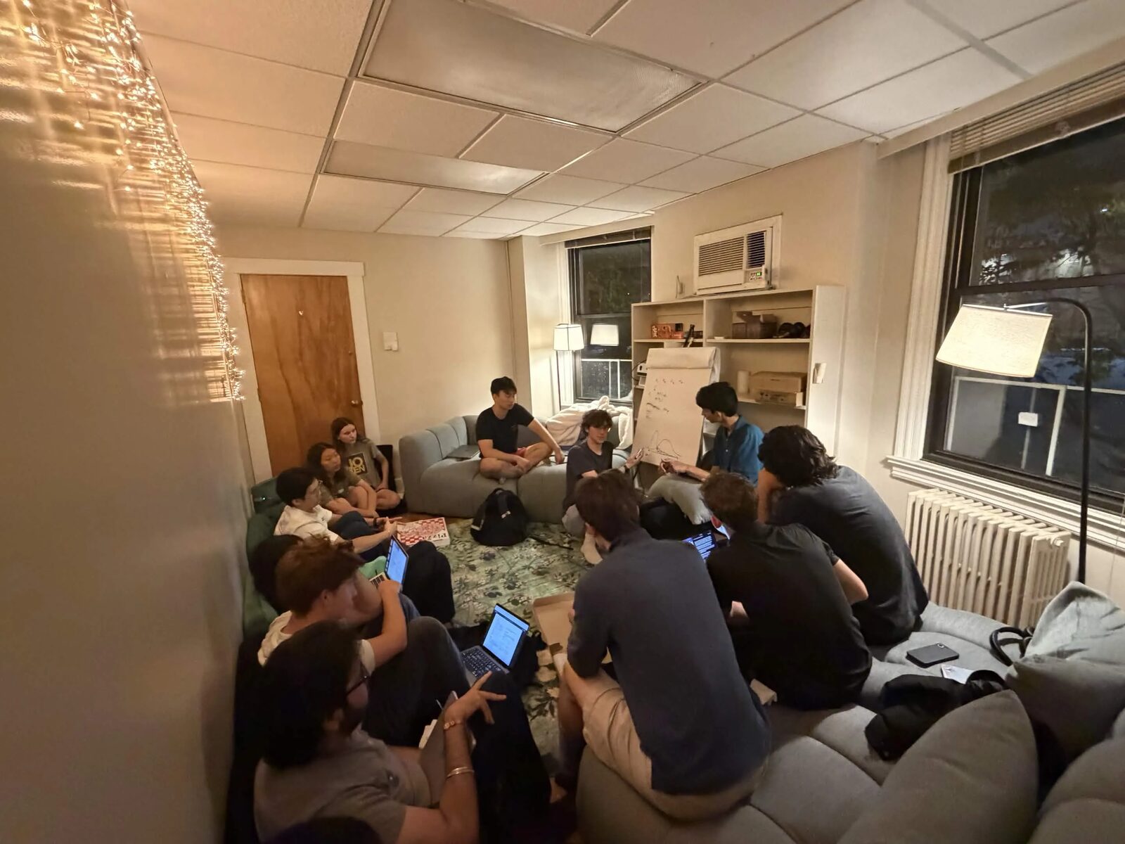 MLn Reading Club, Week 17 — the group on the couches and the rug at CASI, laptops open, the flip chart by the window